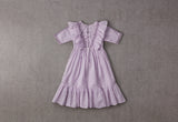 Purple cotton birthday dress with a row of bows