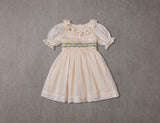 Embroidered beige cotton flower girl dress with smocking