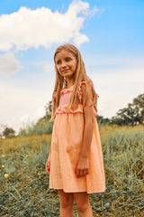 Above knee peach cotton birthday dress with floral embroidery and smocking