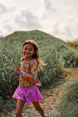 Pink cotton shorts with multi-coloured tassels