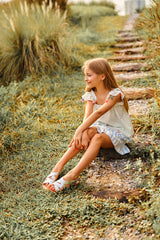 Above knee white floral cotton ruffle skirt with piping