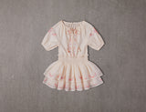 Above knee tiered beige cotton birthday dress with pompoms