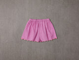 Pink cotton shorts with multi-coloured tassels