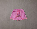 Pink cotton shorts with multi-coloured tassels