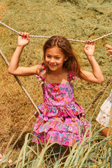 Knee length pink floral cotton birthday dress with pompoms