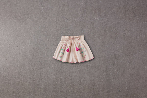 Cream linen flared shorts with pompoms