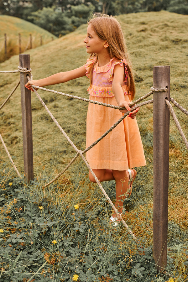 Above knee peach cotton birthday dress with floral embroidery and smocking