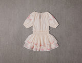 Above knee tiered beige cotton birthday dress with pompoms