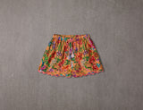 Peach cotton shorts with multi-coloured tassels