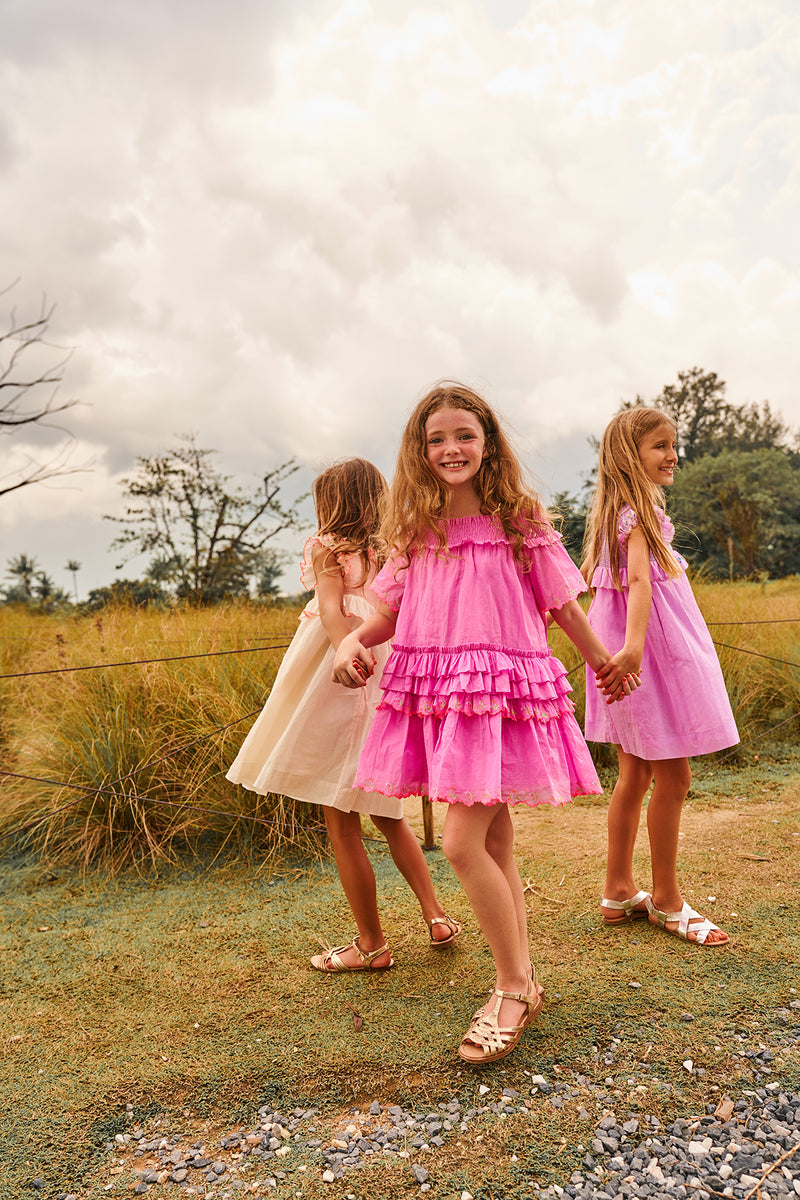 Tessa Dress | Knee length pink cotton off-shoulder birthday dress with smocking NELLYSTELLA Tessa Dress | Knee length pink cotton off-shoulder birthday dress with smocking NELLYSTELLA